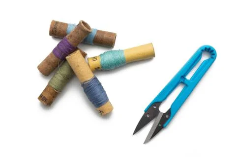 Group of thread spools white background with repairing scissors Stock Photos