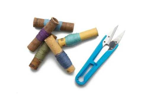 Group of thread spools white background with repairing scissors Stock Photos