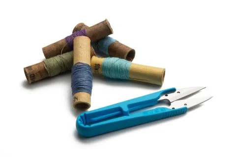 Group of thread spools white background with repairing scissors Stock Photos