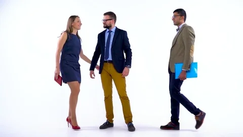 Group of three business partners posing in studio for camera. Slow motion Stock Footage 80034416