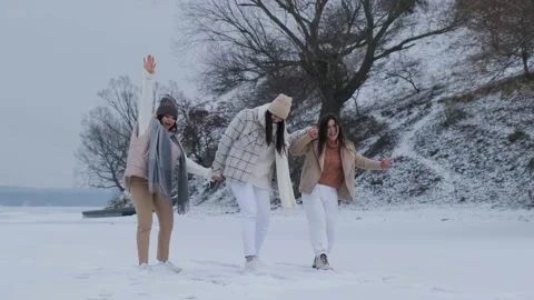Group of three happy friends having fun and playing together in winter park. Stock Footage 147274743