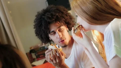 A group of three hipster eating and having fun using a tablet computer Stock Footage 54938603