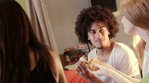 A group of three hipster eating and having fun using a tablet computer Stock Footage 54938604