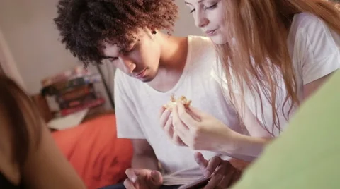 A group of three hipster eating and having fun using a tablet computer Stock Footage 54938650