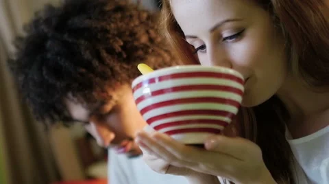 A group of three hipster eating and having fun using a tablet computer Stock Footage 54938651