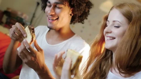 A group of three hipster eating and having fun using a tablet computer Stock Footage 54938667