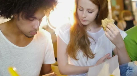 A group of three hipster eating and having fun using a tablet computer Stock Footage 54938712
