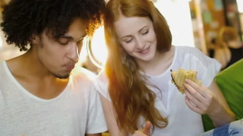 A group of three hipster eating and having fun using a tablet computer Stock Footage 54938757