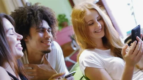 A group of three hipster fun using a smart phones Stock Footage 54937530