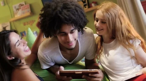A group of three hipster fun using a tablet computer Stock Footage 54938924