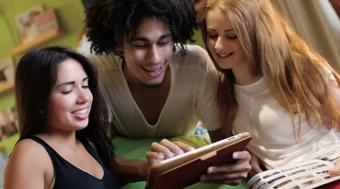 A group of three hipster fun using a tablet computer Stock Footage 54938929