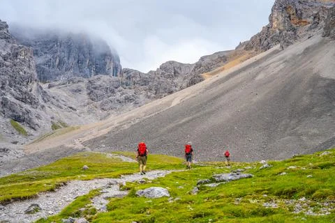 Group of three men in the mountains Stock Photos