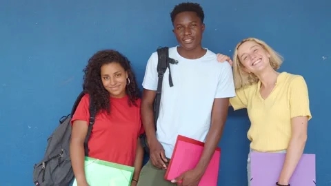 Group of three multi-ethnic teenage students with backpack and folders Stock Footage 202165053