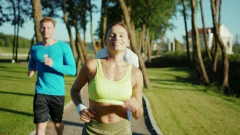 Group of three multi-race happy friends jogging in the country park enjoying Stock Footage 139583991