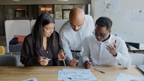 A group of three professionals discusses finance strategies and market analysis 스톡 동영상 335732335