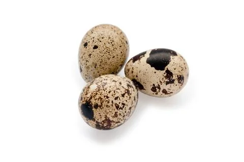 Group of three quail eggs with shadows isolated on white background Stock Photos