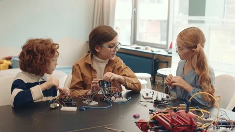 Group of Three School Kids Constructing Robots Video stock 153464222