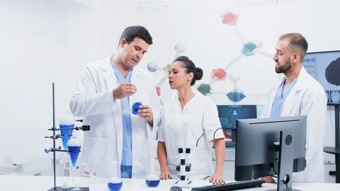 Group of three scientists in modern laboratory Stock Footage 114560621