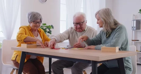 Group of three senior people in the retirement home playing a brain game Stock Footage 317476980