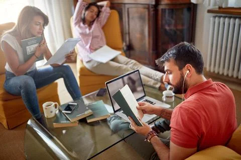 Group of three students writing paper together Stock Photos
