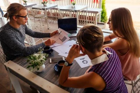 A group of three stylish freelancing students entrepreneurs in fashion well Stock Photos