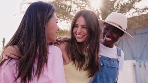 Group of three young multi-ethnic beautiful women enjoying embracing walk Stock Footage 267484903
