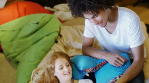 Group of three young people sitting on the couch talking Stock Footage 54938242