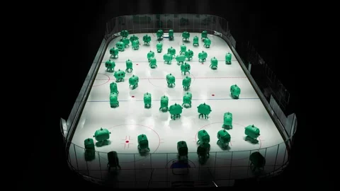 A group of tiny green robots slide around on an ice rink or hockey rink Stockbeeldmateriaal 245833482