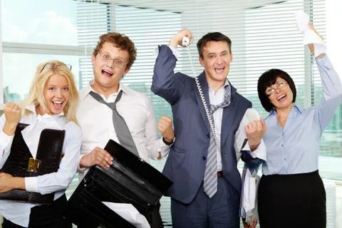 Group of tired businesspeople showing gladness after making excellent deal Stock Photos