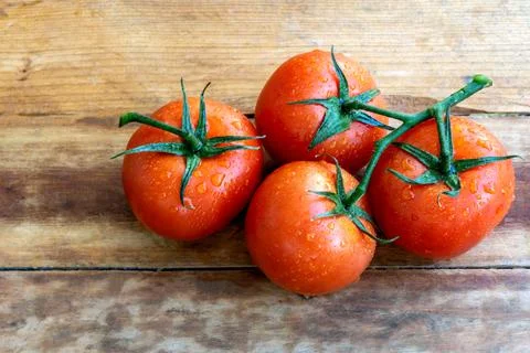 A group tomatoes on wood table background Stock Photos