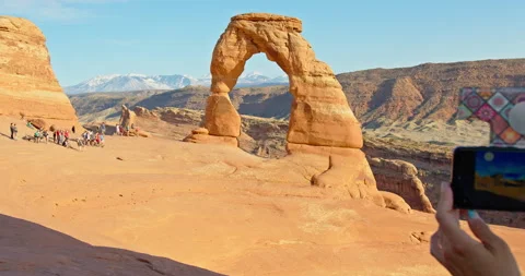 Group of tourists at Delicate Arch 4K Stock Footage 154274342