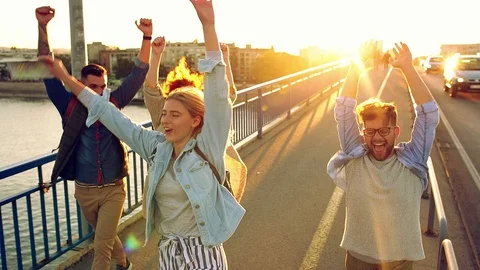 Group of tourists enjoying and having fun walking on city street. Stock Footage 120530741
