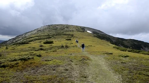 A group of tourists go to the mountain Stock Footage 73565112