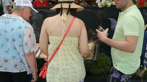 Group of tourists looking through menu on street Stock Footage 96354755
