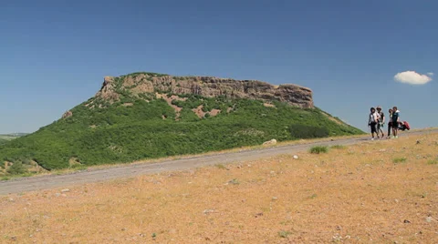 Group of tourists passing by huge rock Stock Footage 33878059