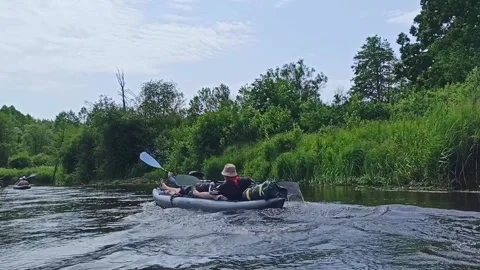 A group of tourists rafting on the river Stock Footage 234883107