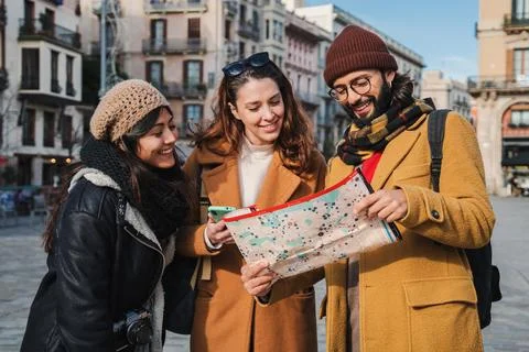 Group of tourists reading a map to found the location of a european monument Stock Photos