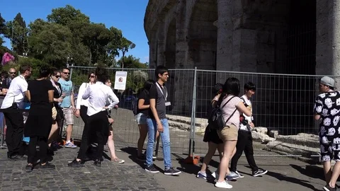 Group of tourists in a row enter the Colosseo-Rome, Italy Stock Footage