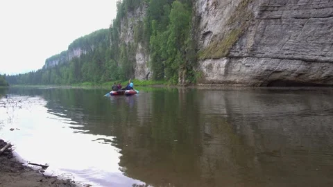 A group of tourists rowing oars on a catamaran on the Usva River, sailing past t Video stock 164384894