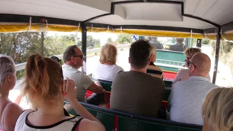 Group of tourists in train moving in the narrow streets of the seaside resort Stock Footage 72267738
