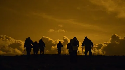 A group of tourists walk through a mountain valley against Stock Footage 290940508