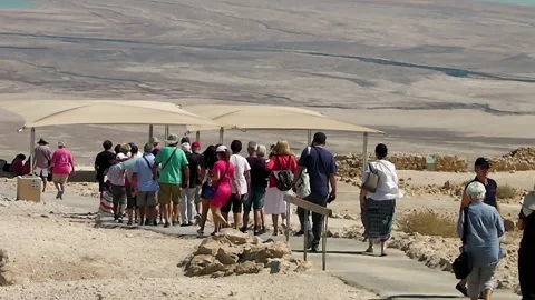 A group of tourists walking in a column during sightseeing. Stock Footage 152686949