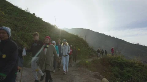 Group of tourists walking at the edge of a mountain Stock Footage 87145730