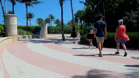 A group of tourists walking over path along South Beach. Video stock 152954197