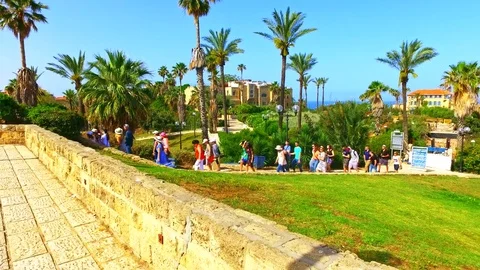 Group of tourists walking streets of Tel Aviv by Mediterranean sea beach Stock Footage 73607360