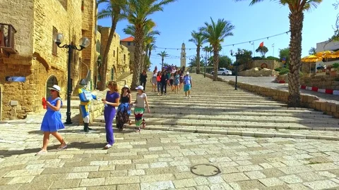 Group of tourists walking streets of Tel Aviv by Mediterranean sea beach Stock Footage 73607445