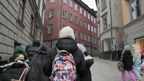 Group of tourists walking through the narrow streets of the central part of Stock Footage 274346565