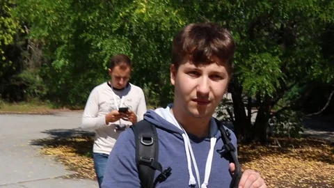 Group of tourists walking through the overgrown town of pripyat inside the ch Stock Footage 129347376