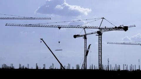 Group of tower cranes in construction site. Stock Photos