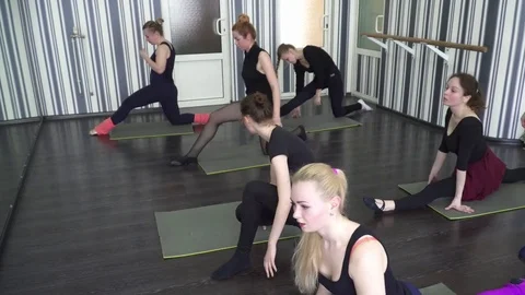 Group of trainees making the stretching exercises in dancing class Stock Footage 75532529